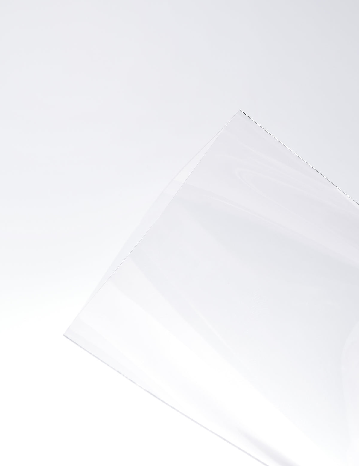 Close-up of K-pop photocard sleeve thickness showing the 100 micron premium material
