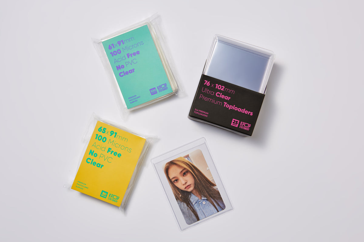 Premium clear toploaders shown with various clear photocard sleeves for double-sleeving and safe trading